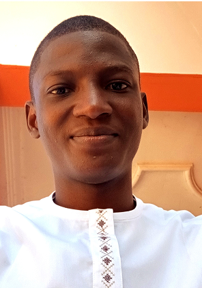 Kenneth Dogara, Social Media Manager at ZATS, smiling and wearing a white shirt.