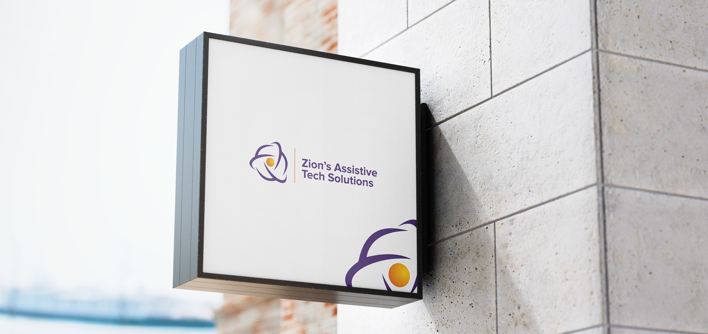 Wall-mounted square sign displaying the logo and name of 'Zion’s Assistive Tech Solutions' in purple text, with a modern abstract icon featuring swirling purple lines and a central yellow dot, mounted on a stone exterior wall.